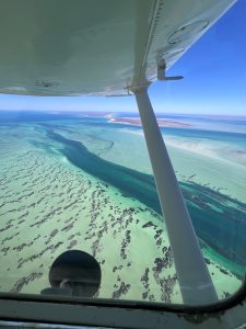 Aerial view of turquoise waters and land.