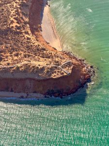 Coastal cliff meeting turquoise water